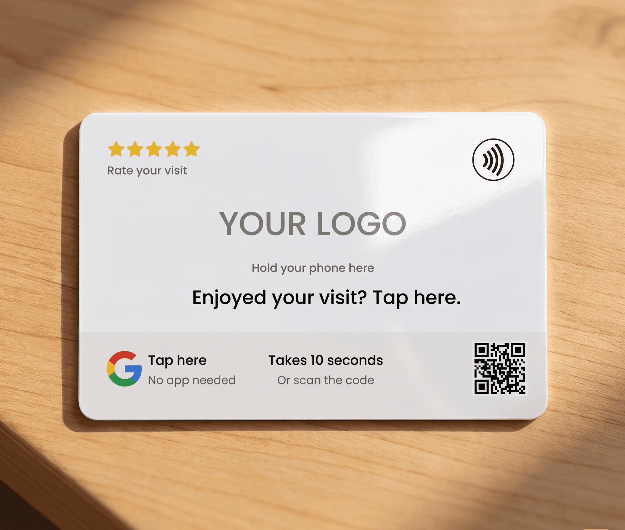 A phone held near a ZapTap card on a counter, with the Google review page opening on screen